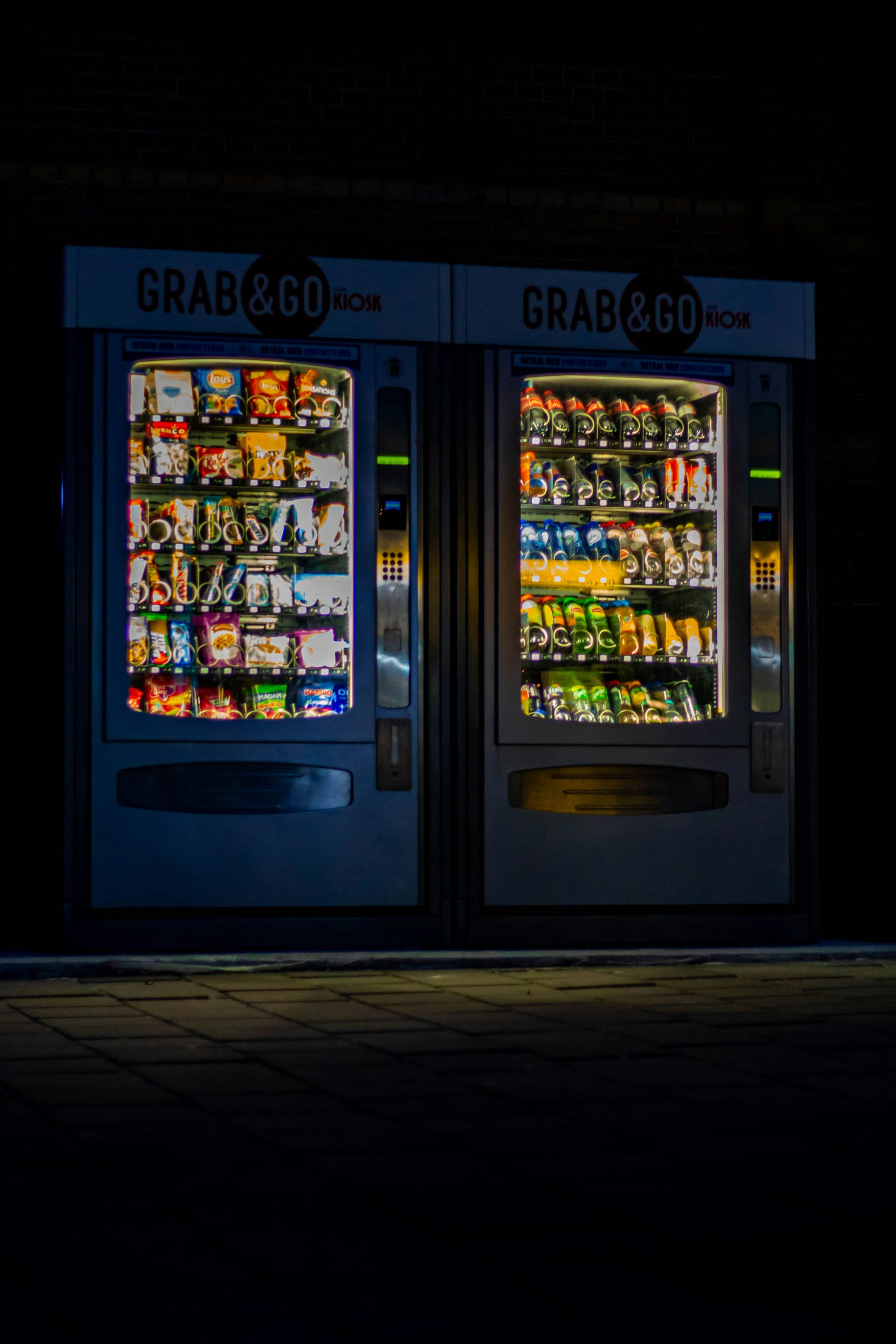 Illuminated YOYO snack and drinks vending machines at night